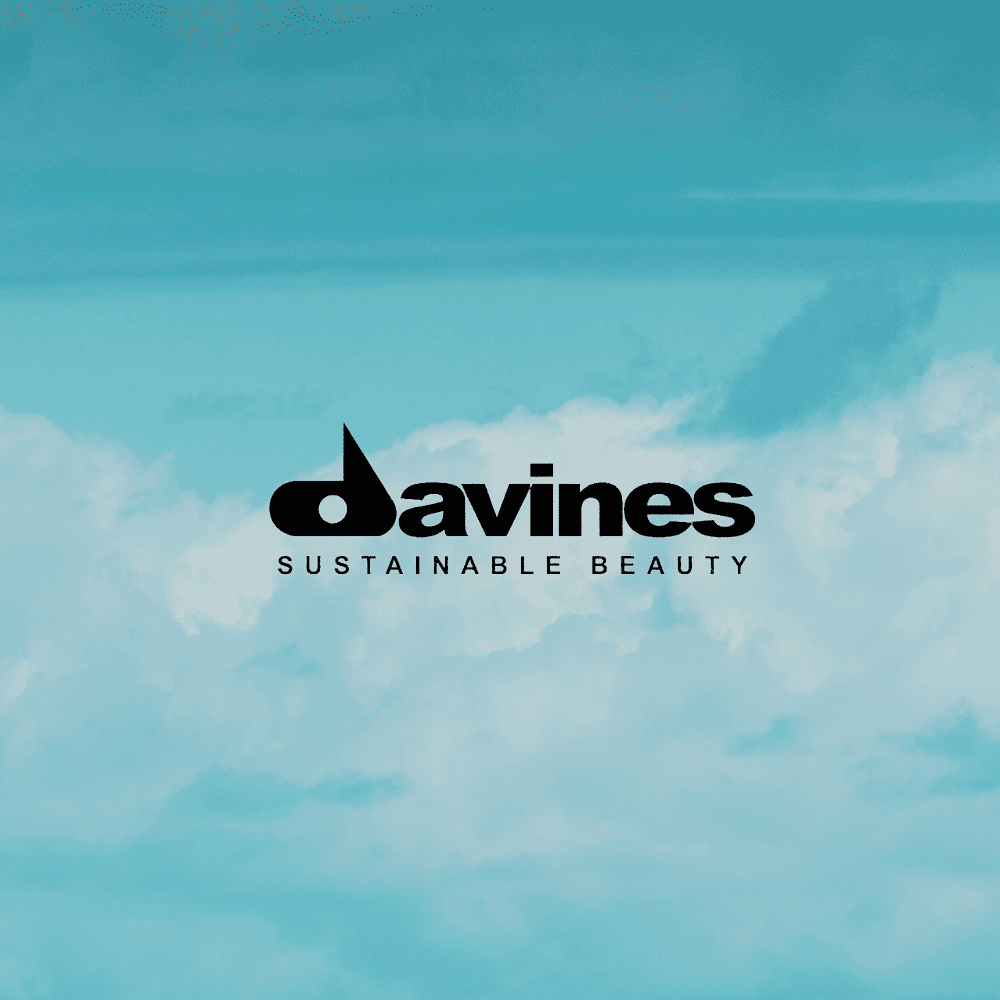 Logo of Davines with the tagline "Sustainable Beauty" set against a cloudy blue sky background.